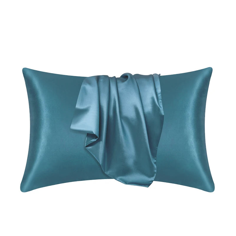 Premium silk pillowcase in teal blue showing luxurious fabric drape and sheen