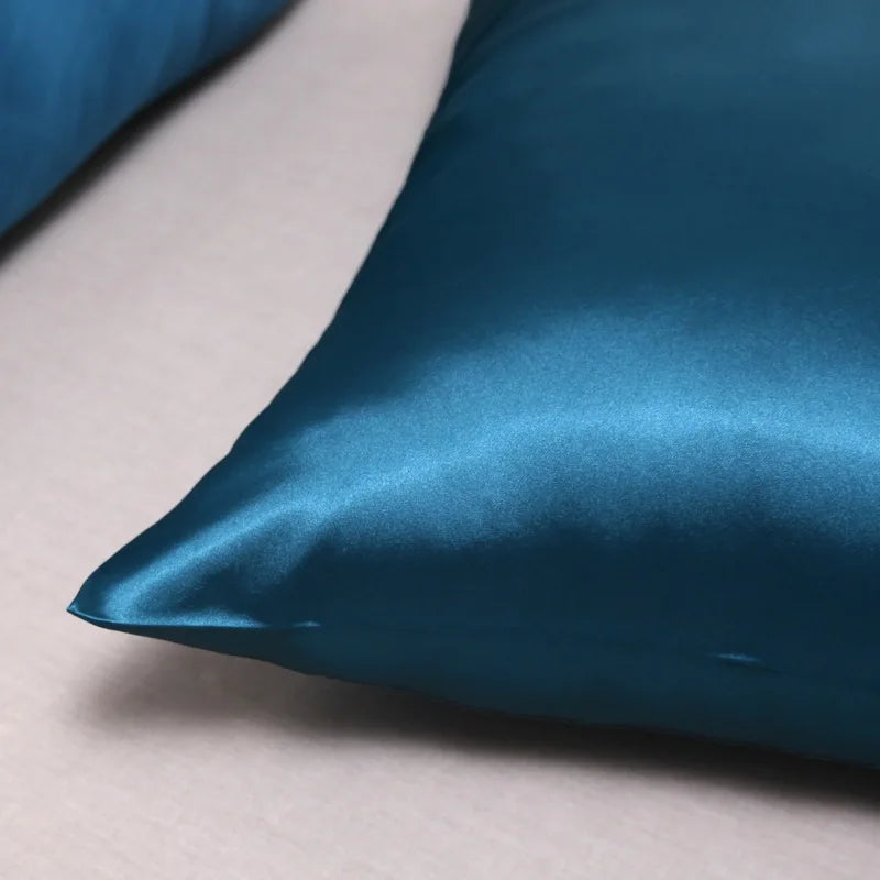 Teal silk pillowcase corner detail showing smooth satin finish