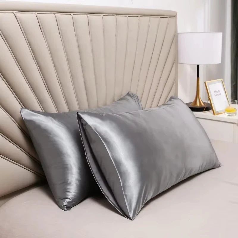 Gray silk pillowcases styled on luxury bed in modern bedroom